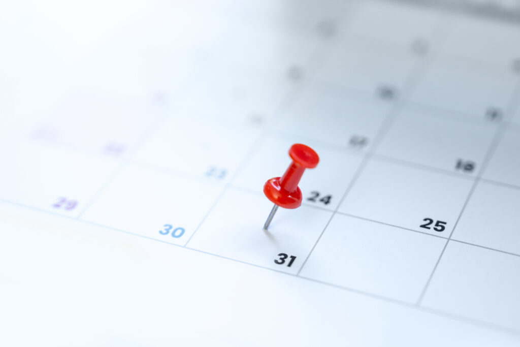 Red pin on the calendar 31st day of the month indicating an important deadline like the statute of limitations 